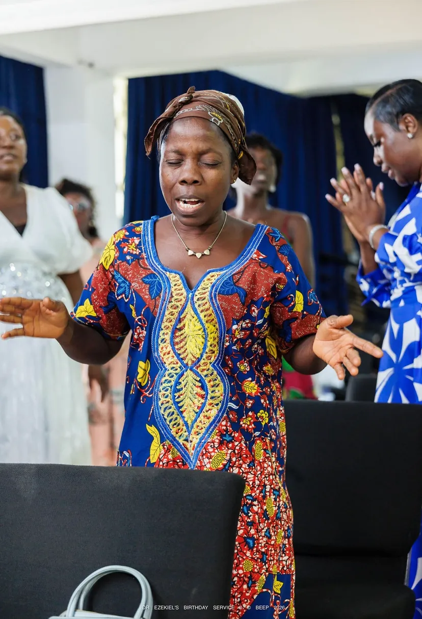 A woman worshipping with her eyes closed